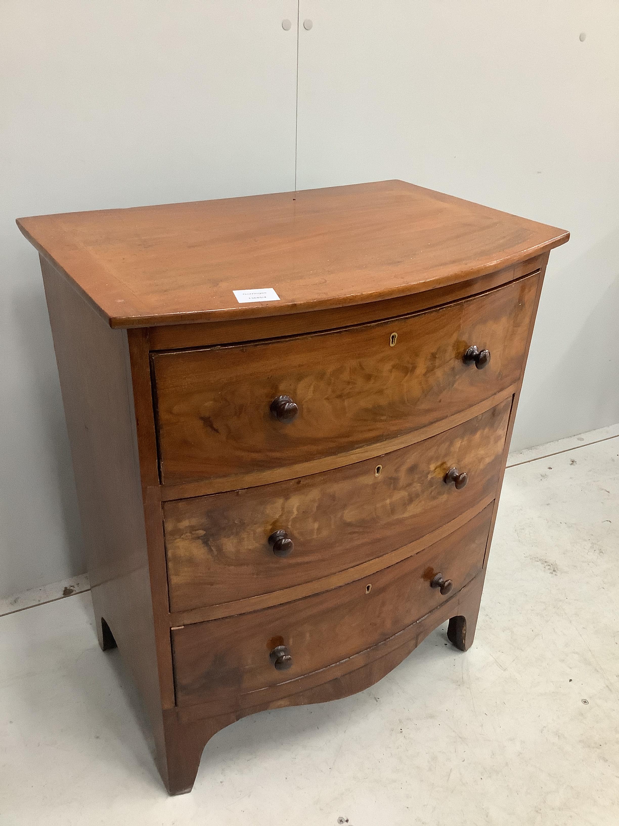 A small Regency mahogany bowfront chest of three drawers, converted from a commode, width 58cm, depth 39cm, height 69cm